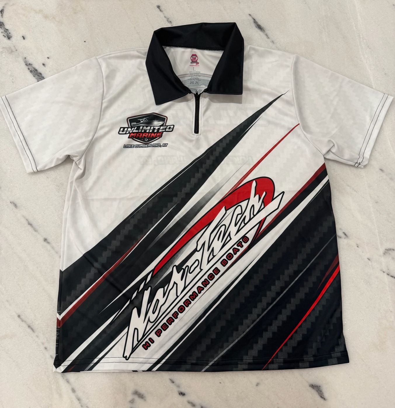 Unlimited Marine and Nor-Tech branded zip polo in white with black and red sublimated stripes